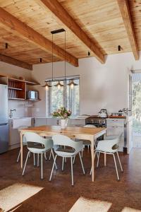 a large kitchen with a wooden table and chairs at Bokrivier Cottages in Greyton +60 photos
