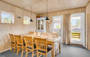 a dining room with a large wooden table and chairs at Holiday Home Hybenvænget Hejls I in Hejls