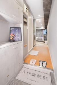 a room with two pairs of shoes on the floor at shinjuku lions house newly renovated, elevator, washmachine,kitchen in Tokyo