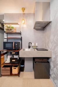 a kitchen with a sink and a microwave at shinjuku lions house newly renovated, elevator, washmachine,kitchen in Tokyo +12 photos