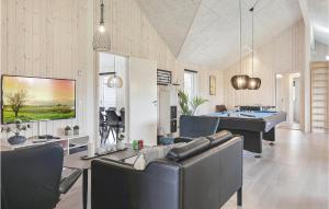 a living room with a couch and a pool table at Beautiful Home In Idestrup With Sauna in Marielyst