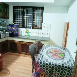 a kitchen with a table and a counter top at JayBee's Homestead in Varkala