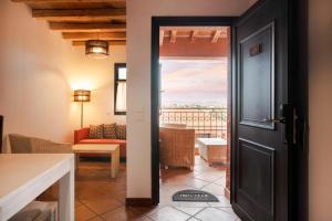 a room with a door leading to a living room at The Varos Residences Hotel in Város