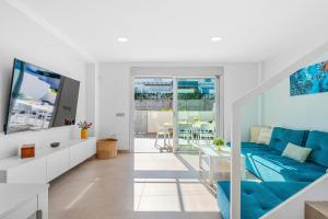 a living room with a blue couch and a table at MEDANO4YOU Lego House in El Médano