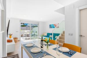 a dining room and living room with a table and chairs at MEDANO4YOU Lego House in El Médano