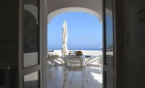 an open door to a patio with a table and chairs at Villa Gioia in Ischia