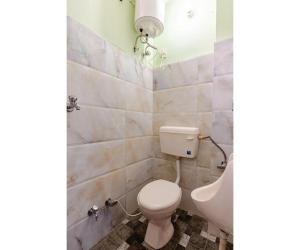 a bathroom with a toilet and a sink at SOHANAs Homestays- 2 BHK Luxury Apartment near Jaipur International Airport in Jaipur +37 photos