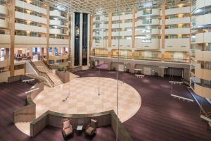 an empty lobby of a building with a table and chairs at Hilton Washington DC/Rockville Hotel & Executive Meeting Center in Rockville