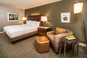 a hotel room with a bed and a chair at Hilton Washington DC/Rockville Hotel & Executive Meeting Center in Rockville +41 photos