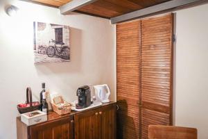 a room with a wooden door with a microwave on a counter at PienzaLettings Studio & Room in Pienza