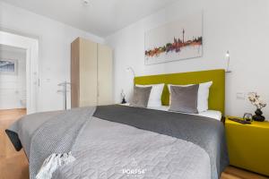 a bedroom with a large bed with a green headboard at Ferienwohnung Zuhause am Meer Olpenitz in Olpenitz
