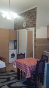 a room with a table and a kitchen with a refrigerator at Apartments Mira in Tivat