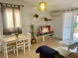a living room with a table and a television at Ático vistas a montaña in Lanjarón