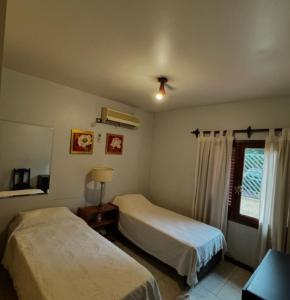 a bedroom with two beds and a window at CASONA COMPLETA jn in Posadas +14 photos