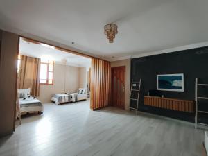 a room with two beds and a black wall at Argan surf house in Taghazout