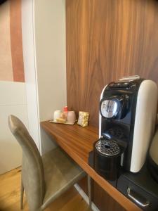 a coffee maker sitting on top of a wooden table at Nonno Nicola Rooms in Bari