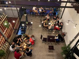 a group of people sitting at tables in a restaurant at Ỉn Homestay & Café in Ha Giang