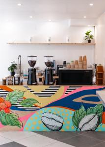 a large room with a colorful floor with two large glasses at TRYP by Wyndham Aruba in Palm-Eagle Beach