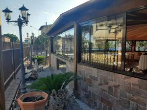 a building with large windows and a street light at Il Rifugio di Dante in Sinalunga