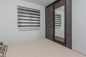 Posteľ alebo postele v izbe v ubytovaní Apartments Lucica
