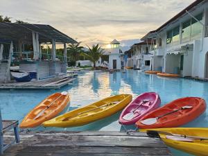 a group of five kayaks sitting on top of a pool at The Oia Pai Resort in Pai
