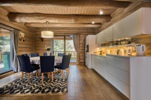 a kitchen and dining room with a table and chairs at Forest Hill Shale in Yablunytsya