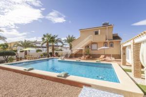 a swimming pool in front of a house at Casa El Sole in Mazarrón