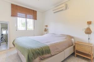 a white bedroom with a bed and a window at Casa El Sole in Mazarrón +36 photos