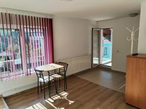 a room with two chairs and a table and windows at Guest House Lila in Bansko