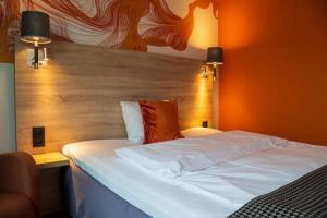 Postel nebo postele na pokoji v ubytování Kysthotellet Rørvik