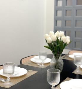 a table with a vase of white flowers on it at Cozy house in Sathani Hat Yai +28 photos