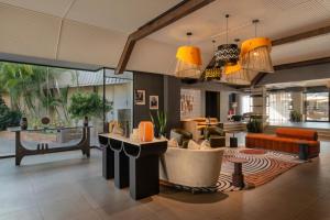 a living room with a lobby with orange furniture at Mercure Hotel Windhoek in Windhoek