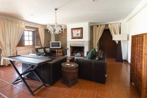 a living room with a table and a couch at Casa do Cerrado in Montalegre