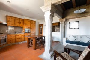 a kitchen and living room with a table and a bed at Casa do Cerrado in Montalegre +2 photos