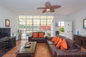 a living room with a couch and a ceiling fan at Villa Montaña Negra I in Las Palmas de Gran Canaria