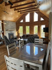 a dining room with a table and a living room at The Wilds at Salmonier River in Salmonier Nature Park +31 photos