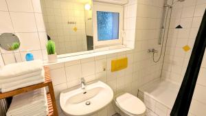 a bathroom with a sink and a toilet and a shower at Gästewohnung Köln-Longerich in Cologne +43 photos