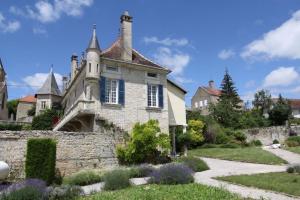 an old house with a stone wall at Le Prieuré de Buffon in Buffon