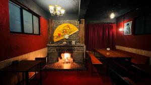 a restaurant with a fireplace in the middle of a room at Pathfinder's Nest Hostel in Darjeeling