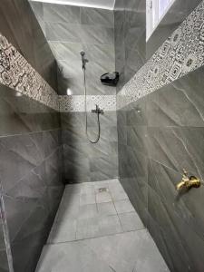 a bathroom with a shower with tiled walls at Riad Sidi Magdoul in Essaouira +149 photos