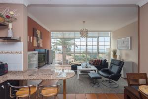a living room with a table and chairs at Villa Montaña Negra III in San Bartolomé de Tirajana