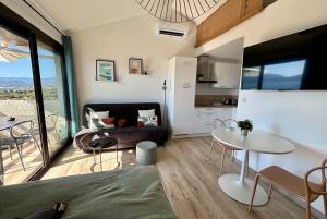 a living room with a couch and a table at Studio Vue Mer à Porticcio Piscine et Parking in Porticcio +11 photos