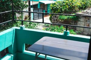a white bench on a balcony with a giraffe at Villas Floralies in Grand-Baie