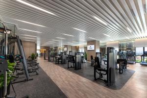 a gym with a lot of treadmills and machines at Wanda Moments Hotel Beijing Dongba in Beijing