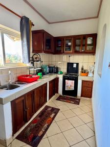 a kitchen with a sink and a stove at Breezy hideaway malindi in Malindi
