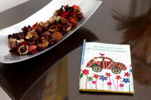 a plate of food on a table with a book at Casa Ines in Rome