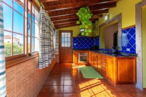 a kitchen with wooden cabinets and a large window at Luz de Luna in La Rosa +22 photos