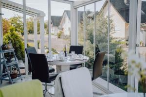 a dining room with a table and chairs at Pension Sterntaler in Rheinhausen