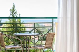 a table and two chairs on a balcony with a view at Julia Hotel in Fourka