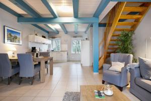 a kitchen and living room with a table and chairs at Fewo Kastanienhof in Pellworm